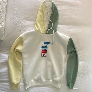 Sweatshirt/hoodie is size s. Cream/off white, pastelish yellow & green in color.